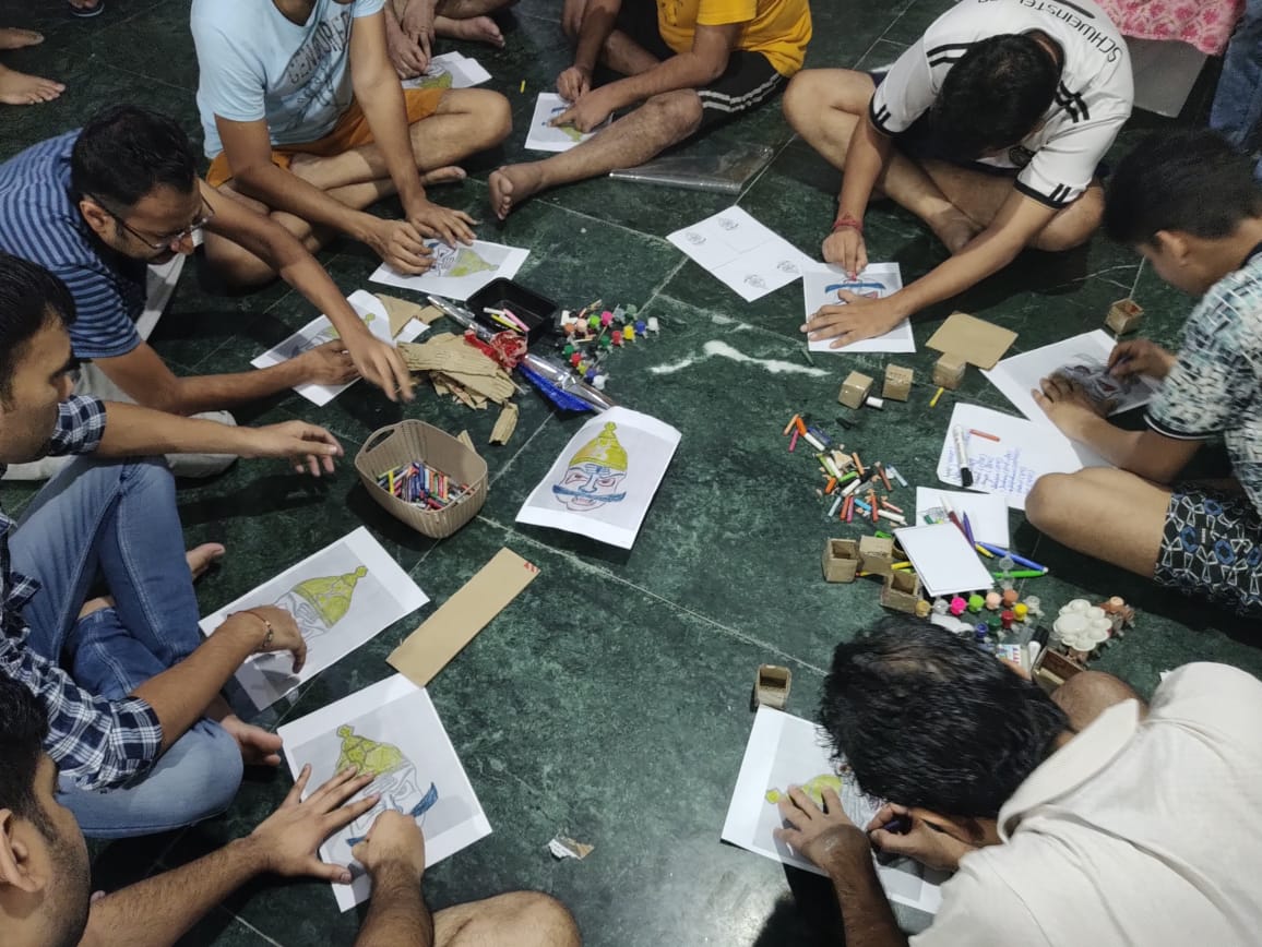 Patients at SimranShri seated in a circle during a group art therapy activity