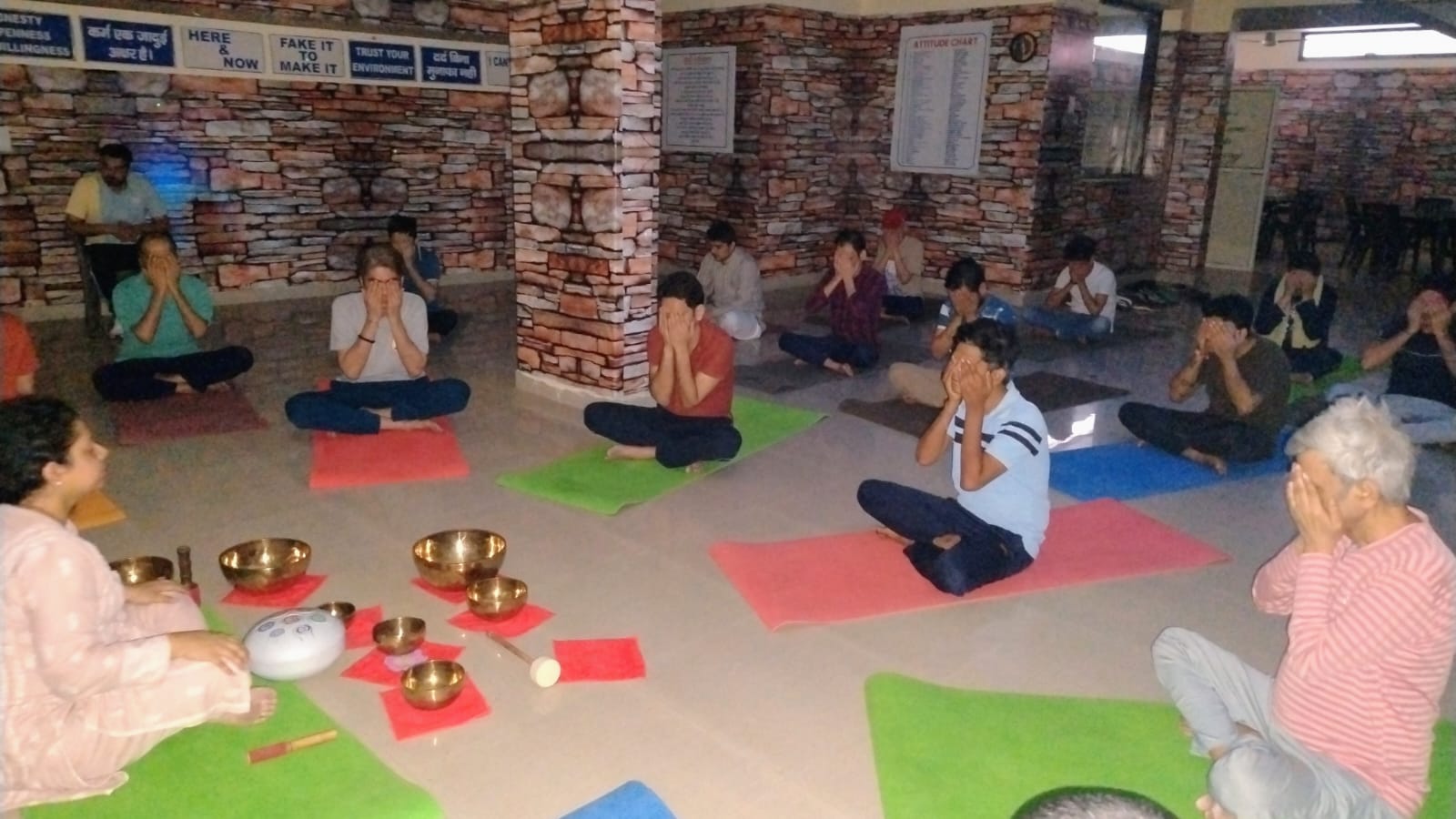 Mindfulness and sound-bowl session at SimranShri with patients seated on yoga mats
