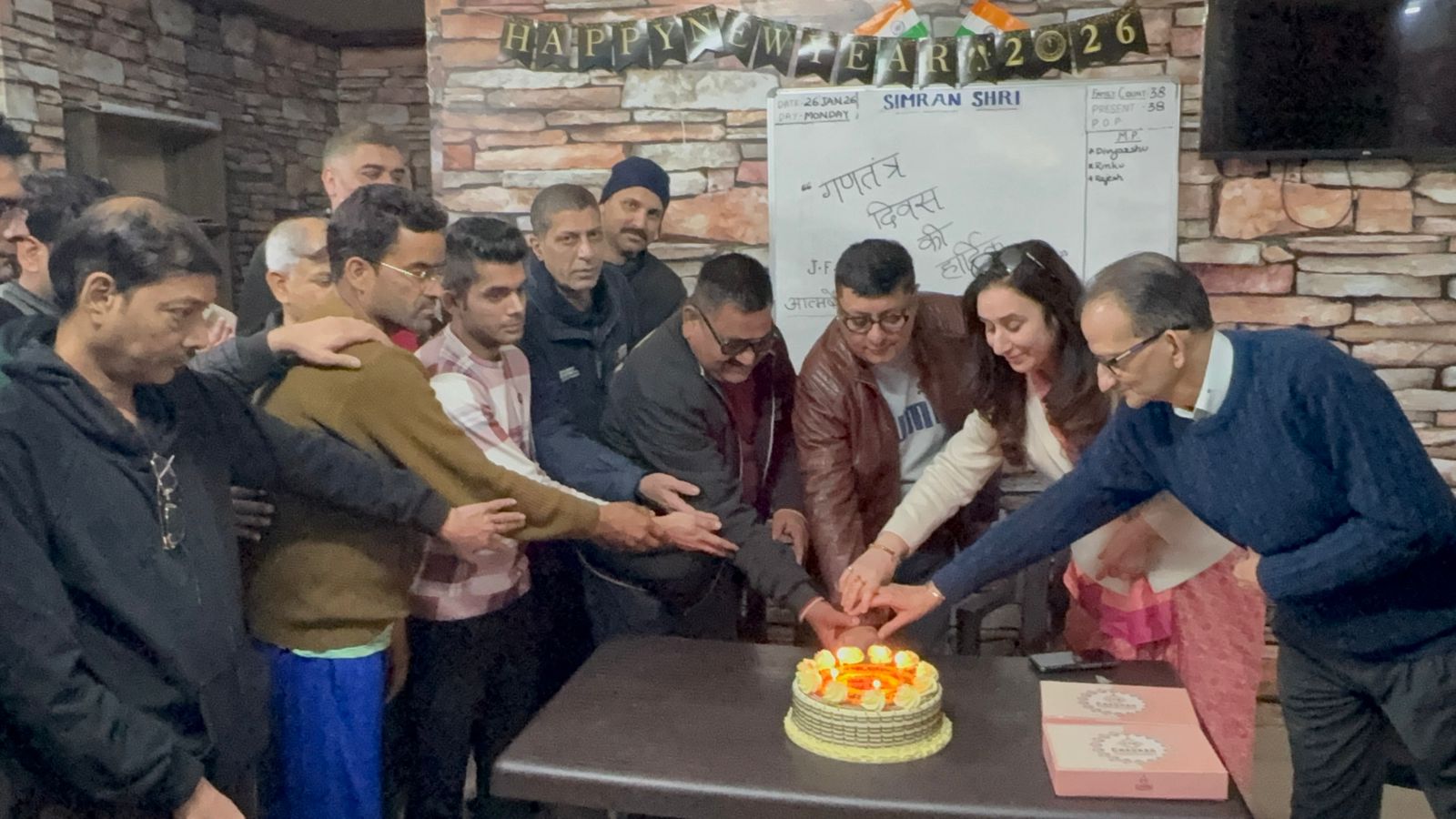 SimranShri patients and staff cutting a New Year cake together
